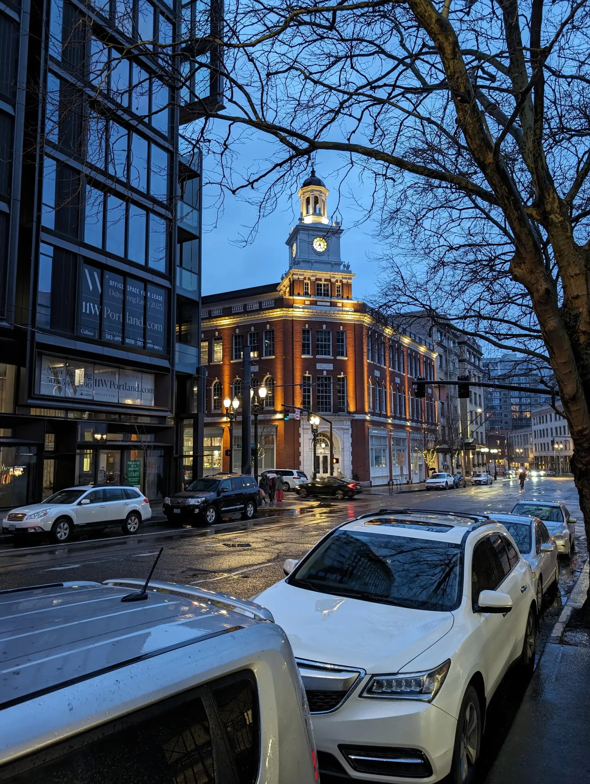 A historic clocktower glowing at blue hour