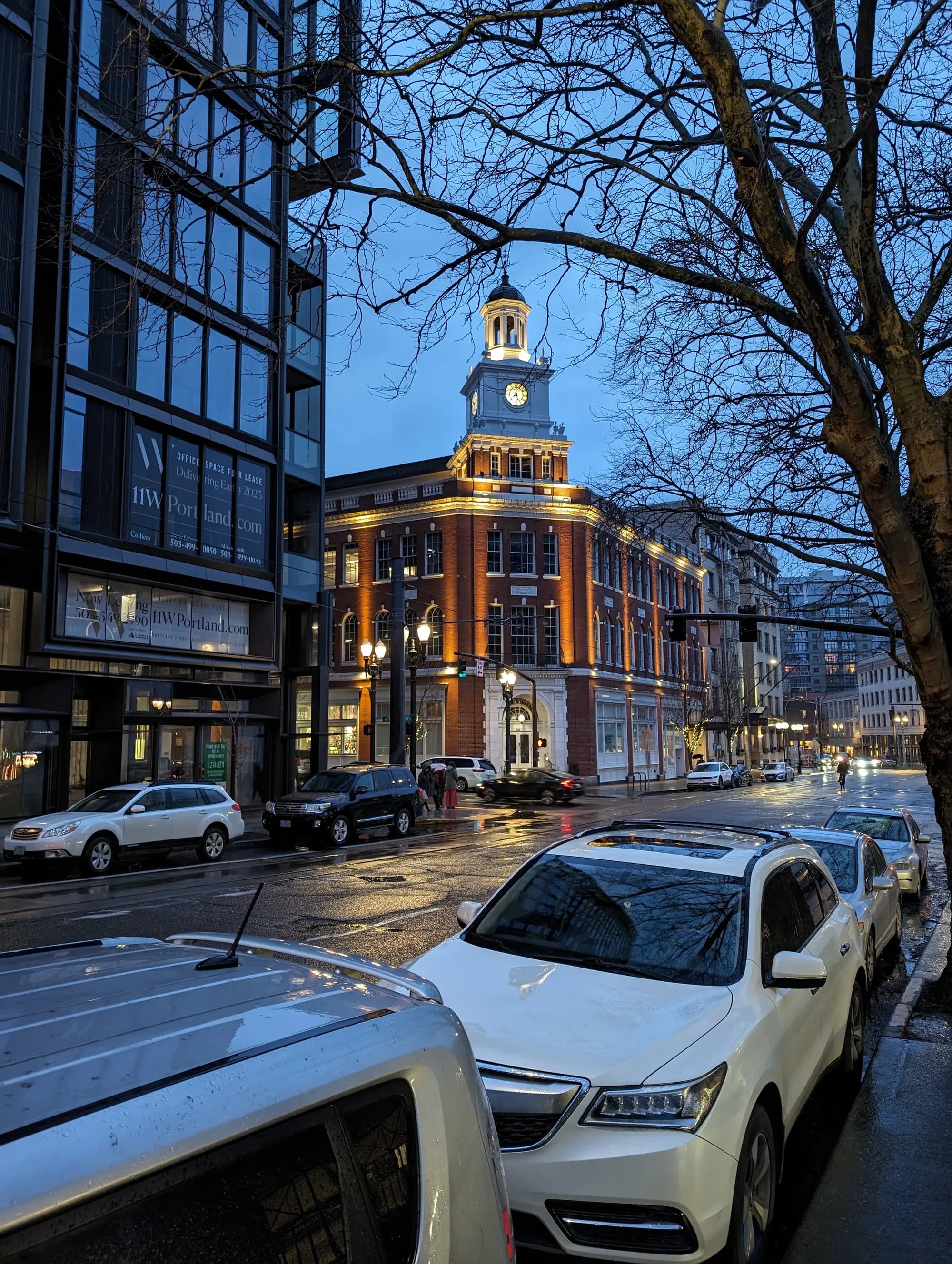 A historic clocktower glowing at blue hour